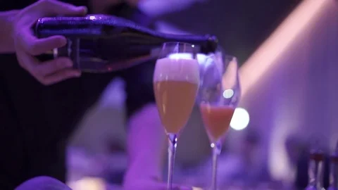 The bartender pours champagne into glasses Stock Footage 71493051