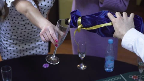 The bartender pours champagne for a visitor 스톡 동영상 164106365