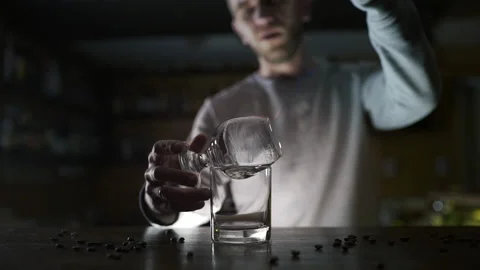 Bartender pours cinnamon powder to the flame of sambuca Stock Footage 143588342