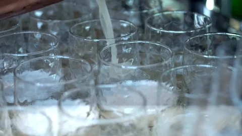 The bartender pours cocktail from the cooper shaker 動画素材 100469655