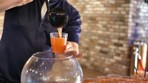 Bartender pours cocktail into glasses.fruit punch Stock Footage 263241002