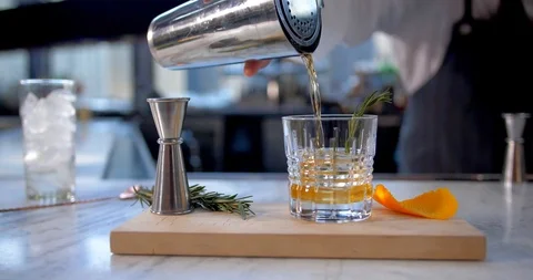 Bartender Pours Cocktail in Upscale Bar Video stock 98880817