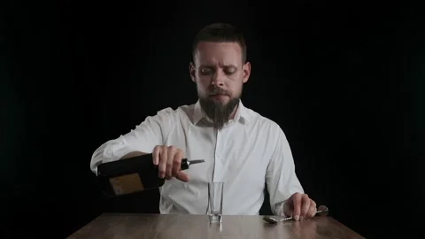 The bartender pours coffee liqueur from a bottle to jigger Stock Footage 132769342