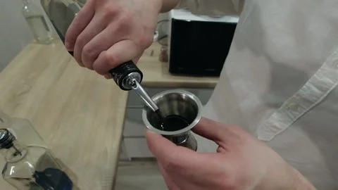 Bartender pours coffee liqueur into jigger and places glass bottle on bar Stock-Footage 134035775
