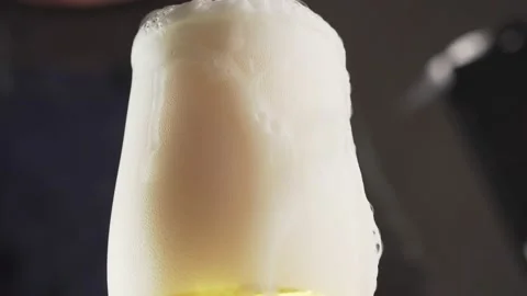 Bartender pours cold beer into a glass and puts it on the bar. Stock Footage 141124121