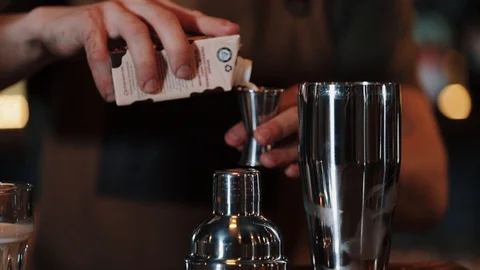 The bartender pours cream into a measuring cup and pours it into shaker. White Stock Footage 129111138