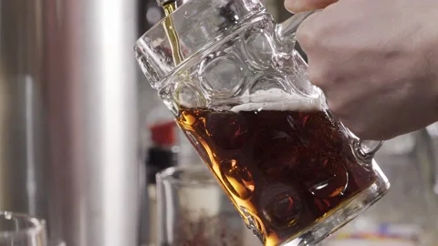 The bartender pours dark beer into a glass. Stock Footage 146576869