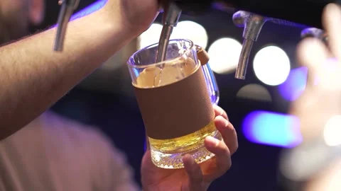 Bartender pours drink in a busy bar during the evening hours. Stock Footage 341498633