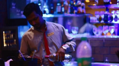 Bartender pours drink into dual measuring cup Stock Footage 65988951