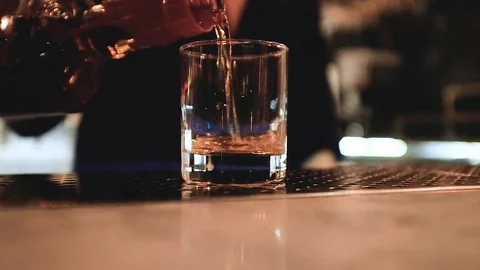 BARTENDER POURS DRINKS Stock Footage