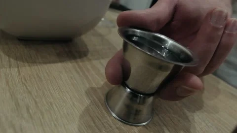 The bartender pours liqueur from jigger to shaker. Slow motion Stock Footage 131546689