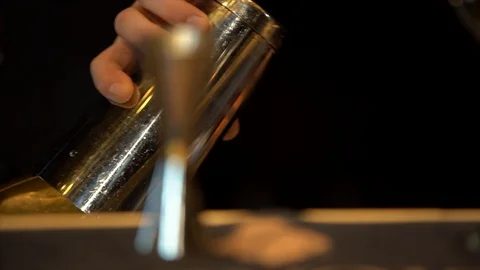 The bartender pours the liquid from one container into the shaker Stock Footage 105025280