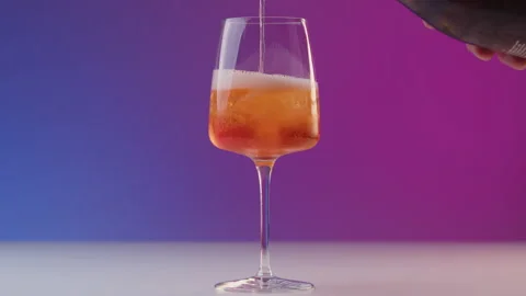 Bartender pours prosecco into long drink glass with ice. Preparation of a summer Stock Footage 239442609