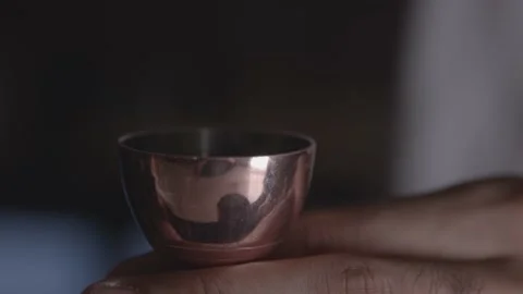 A bartender pours a red liquid into his copper measuring cup in close-up Stock Footage 135451909