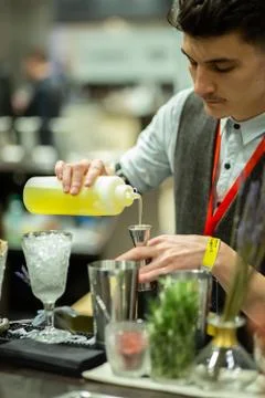 Bartender pours syrup into a jigger Stock Photos