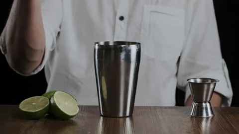 The bartender pours vodka into the shaker. Slow motion Stock Footage 132772457