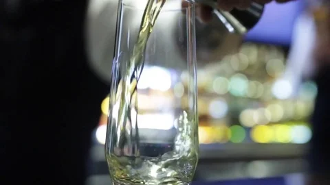 The bartender pours whiskey into a glass Stock Footage 79934606
