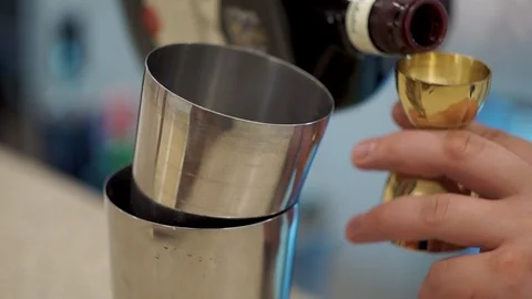 Bartender pours whiskey into a jigger 1 Video stock 101968012