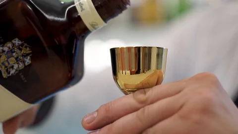 Bartender pours whiskey into a jigger Stock Footage 101967997