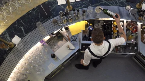 The bartender pours wine into the glasses in 4K Stock Footage 120727044