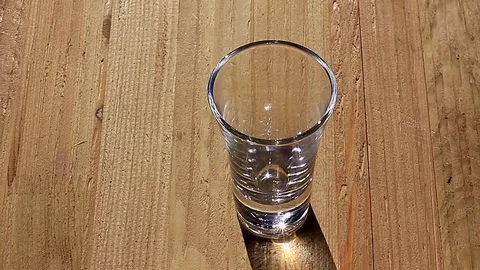 Bartender pours yellow liquor Stock Footage 74844173