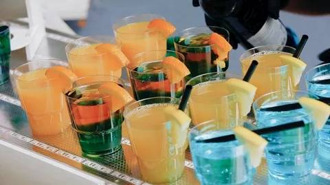 The bartender prepares beautiful cocktail drinks. Close up. Beautiful color Видео 124700731