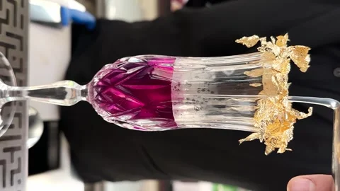 Bartender prepares a cocktail, pour water into a Crystal Glass. The glass is Stock Footage 246474005