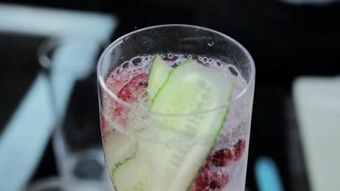 Bartender prepares a delicious cocktail with lemonade, cucumber and strawberry Video stock 315509616