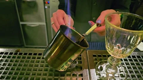 Bartender prepares a dramatic flaming drink in a cocktail lounge, with blue Stock Footage 339846949