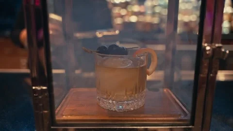 Bartender prepares elegant smoked old fashioned cocktail whiskey drink smoker Stock Footage 280507770