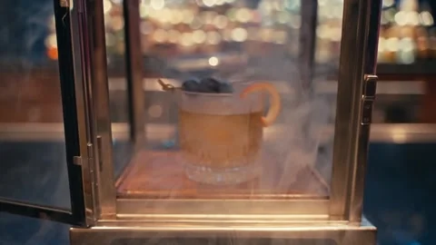 Bartender prepares elegant smoked old fashioned cocktail whiskey drink smoker 動画素材 280507780