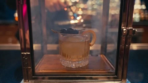 Bartender prepares elegant smoked old fashioned cocktail whiskey drink smoker Stock Footage 280507781