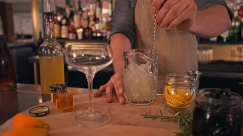 Bartender prepares modern cocktail in martini glass with garnish cinematic Видео 280514686