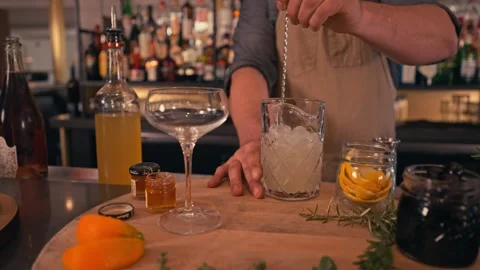 Bartender prepares modern cocktail in martini glass with garnish cinematic Видео 280514690