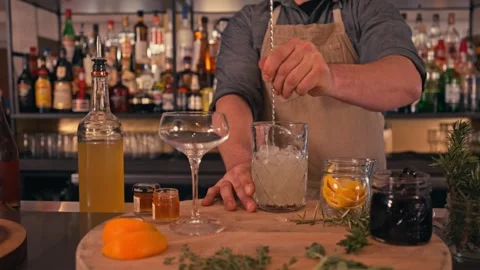 Bartender prepares modern cocktail in martini glass with garnish cinematic Видео 280514694