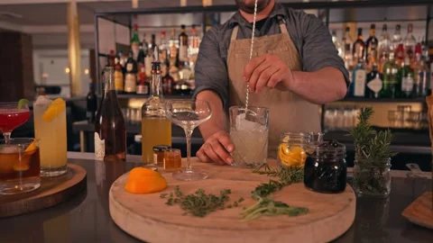 Bartender prepares modern cocktail in martini glass with garnish cinematic Vídeos de archivo 280514697