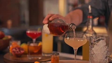 Bartender prepares modern cocktail in martini glass with garnish cinematic Video stock 280514700