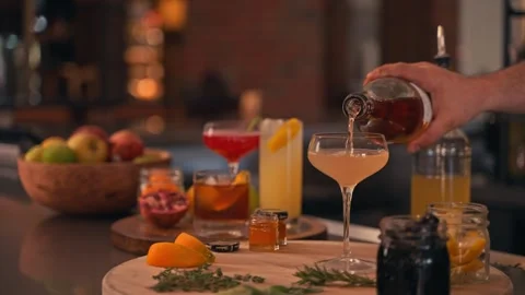 Bartender prepares modern cocktail in martini glass with garnish cinematic 動画素材 280514712