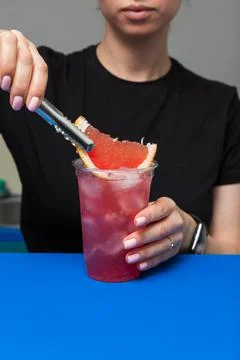 Bartender prepares a refreshing summer cocktail with ice Фото