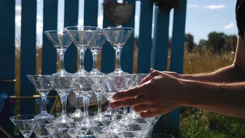The bartender prepares a tower of glasses for the festive event Stock Footage 140538692