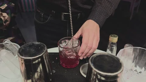 Bartender prepares vibrant alco beverage Stock Footage 294928103