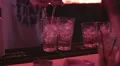 Bartender preparing alcohol cocktail, rotating two bottles simultaneously HD Footage