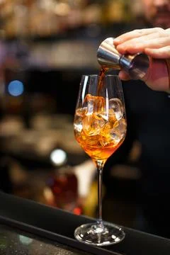 Bartender is preparing an aperol cocktail. Stock Photos