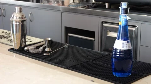 Bartender preparing Blue lagoon cocktail sitting near shaker, jigger, bar s.. Stock Footage 315531009