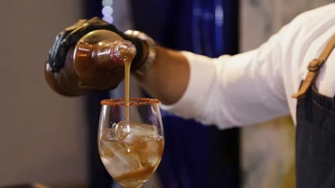Bartender preparing a cocktail on a bar counter. Making tamarind juice from a Stock Footage 147680282