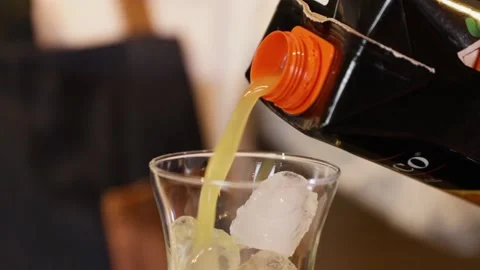 Bartender preparing a cocktail on a bar counter. Pouring orange juice into a Stock Footage 147680289
