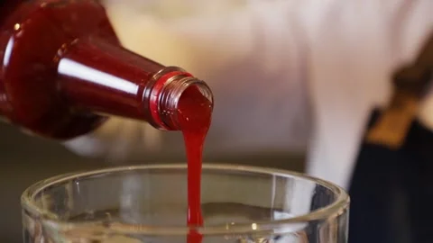 Bartender preparing a cocktail on a bar counter. Making strawberry juice in a Stock Footage 147680309