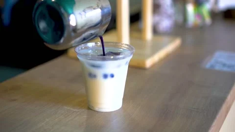 Bartender preparing a cocktail. Bartender preparing a white cocktail Stock Footage 148999041