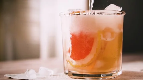 Bartender is preparing a cocktail with grapefruit and ice, slow motion. Stock Footage 123863235