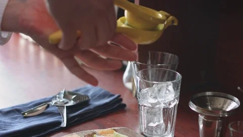 Bartender preparing cocktail with ice and lime Stock Footage 74216279